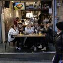 People eat at a restaurant in Jerusalem's main market after authorities reopened restaurants, bars and cafes to "green pass" holders (proof of having received a covid-19 vaccine), on March 11, 2021. (Photo by Emmanuel DUNAND / AFP)