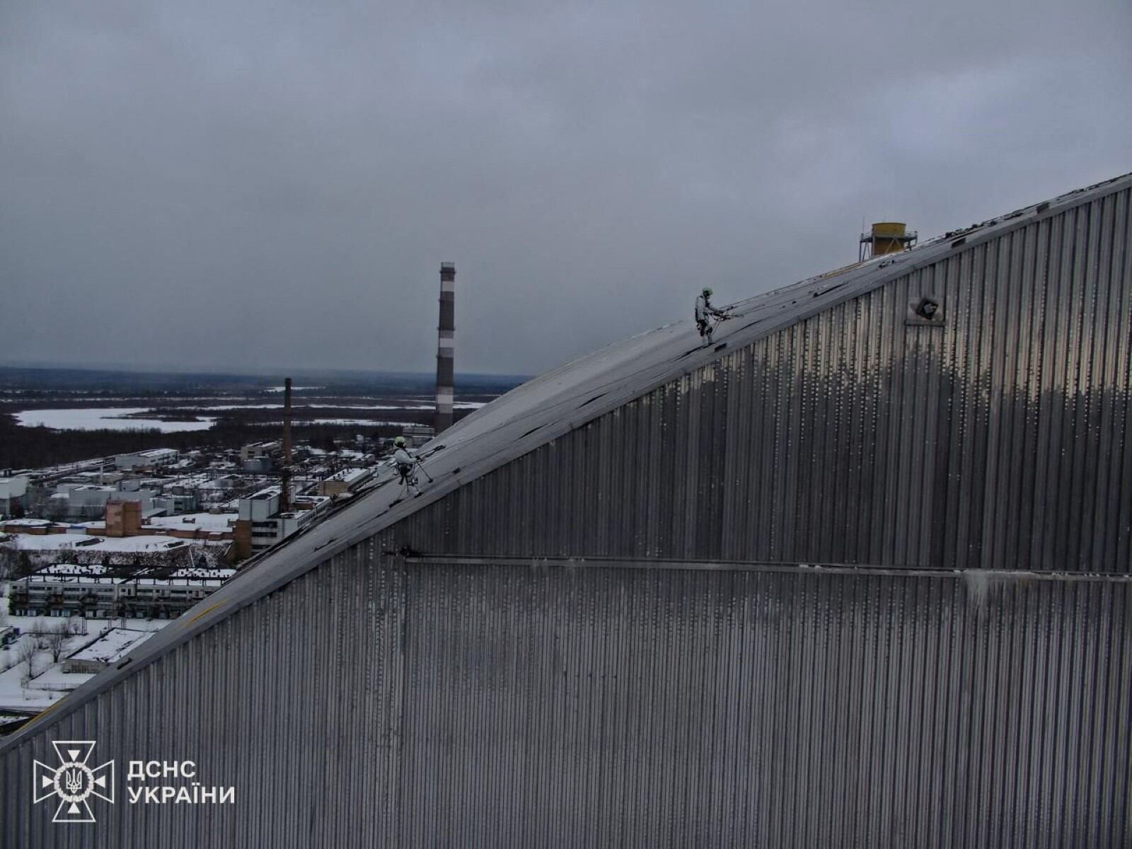 Esta fotografía tomada y publicada por el Servicio de Emergencia de Ucrania el 21 de febrero de 2025 muestra a los empleados trabajando en el Nuevo Confinamiento Seguro (NSC), que protege los restos del reactor 4 en la antigua central nuclear de Chernobyl, tras un ataque con drones a su cubierta construida para contener la radiación, en medio de la invasión rusa en Ucrania. (Foto de Handout / SERVICIO DE EMERGENCIA DE UCRANIANO / AFP) / RESTRINGIDO A USO EDITORIAL - CRÉDITO OBLIGATORIO "AFP FOTO / SERVICIO DE EMERGENCIA DE UCRANIANO " - SIN MARKETING NI CAMPAÑAS PUBLICITARIAS - DISTRIBUIDO COMO SERVICIO A LOS CLIENTES