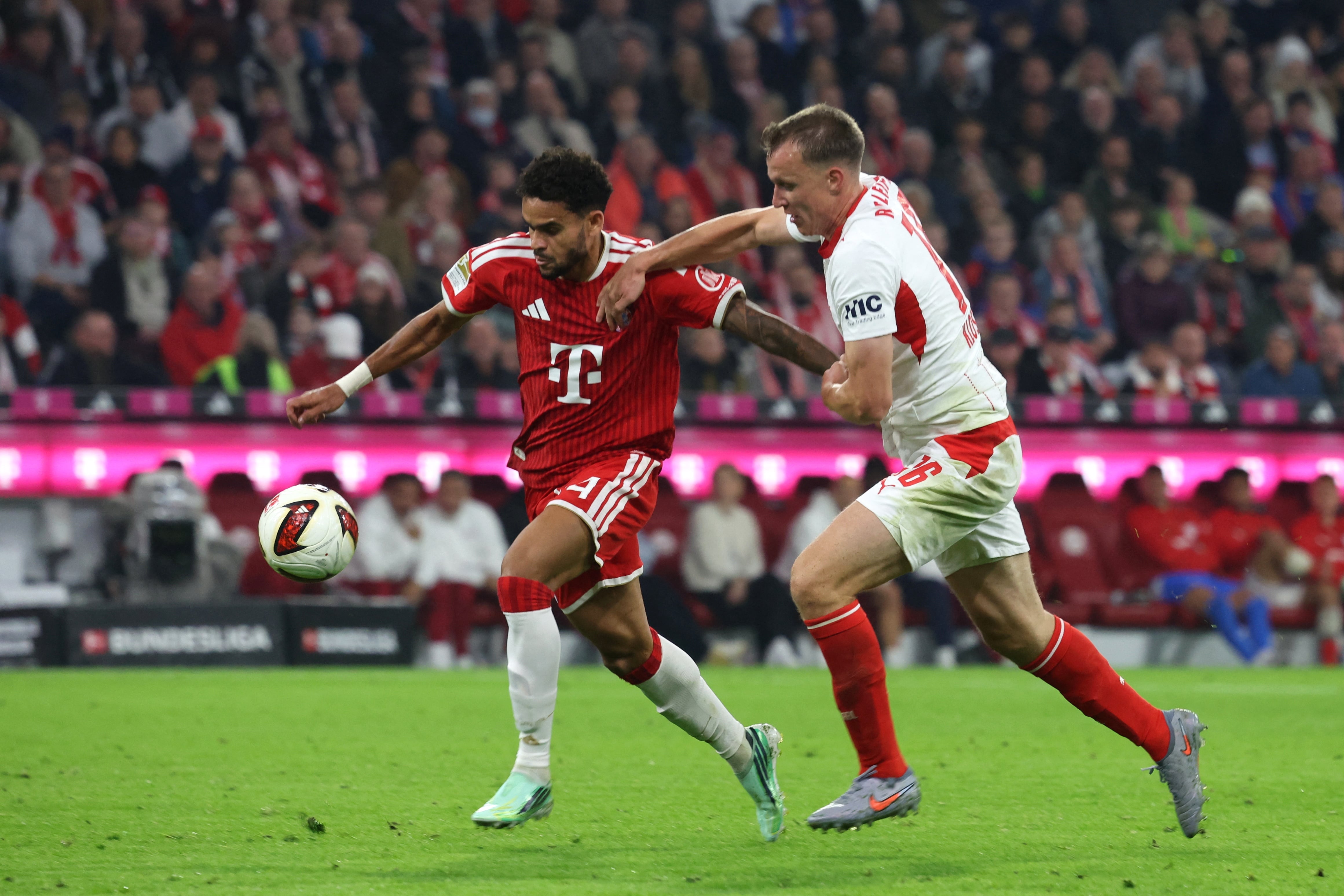 Bayern's Luis Díaz, left, and Leipzig's Lukas Klostermann fight for the ball during the Bundesliga soccer match between Bayern Munich and Leipzig, in Munich, Germany, Saturday Oct. 17, 2026. (Karl-Josef Hildenbrand/dpa via AP)