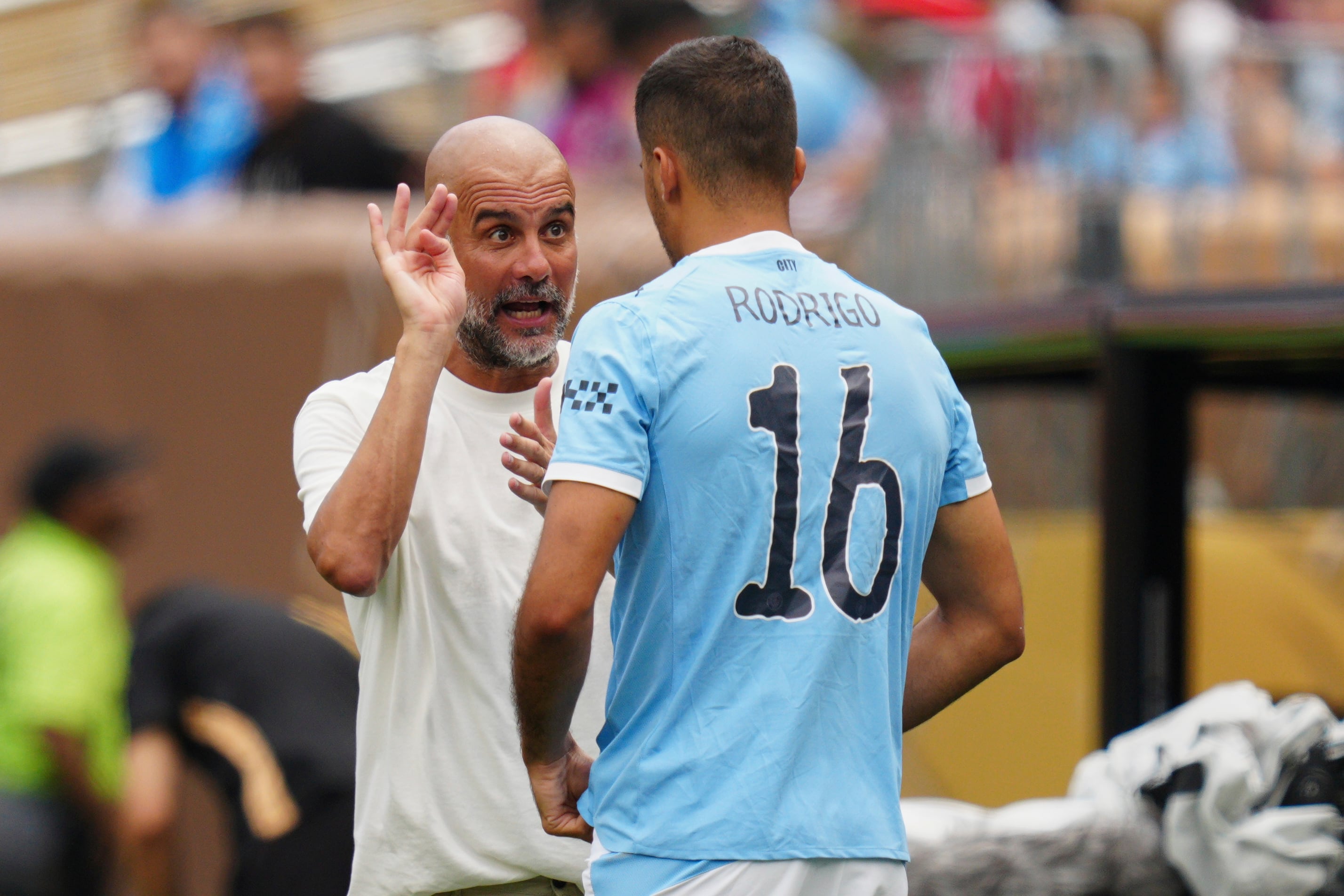 Manchester City manager Pep Guardiola talks to Rodri during the Club World Cup group G soccer match between Manchester City and Wydad AC in Philadelphia, Wednesday, June 18, 2025. (AP Photo/Derik Hamilton)
