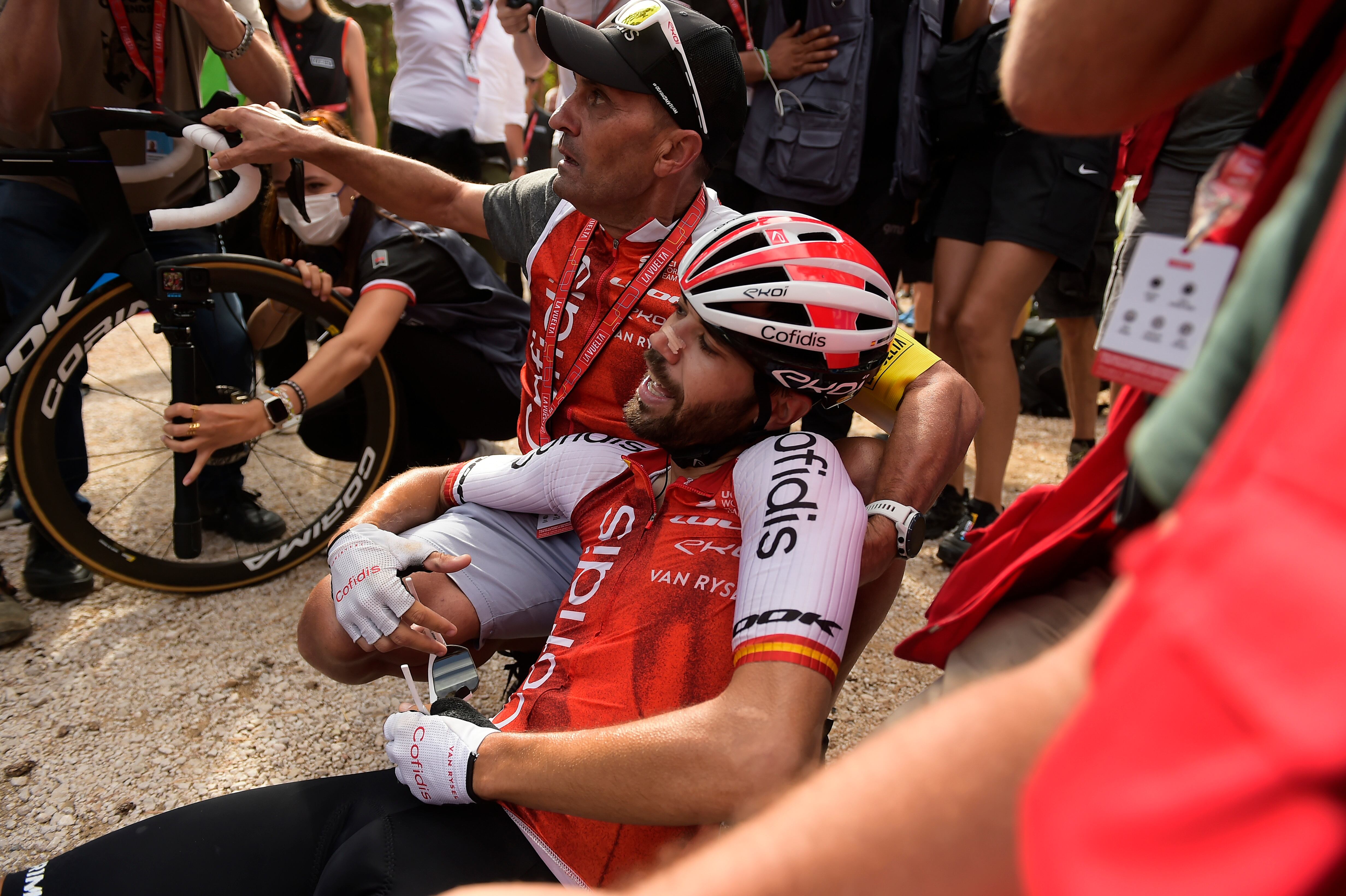 Cofidis' Jesus Herrada is tended by an assistant after winning the eleventh stage of La Vuelta between Lerma and La Laguna Negra-Vinuesa, 163 km (101 miles) in Vinuesa, northern Spain, Wednesday, Sept. 6 2023. (AP Photo/Alvaro Barrientos)