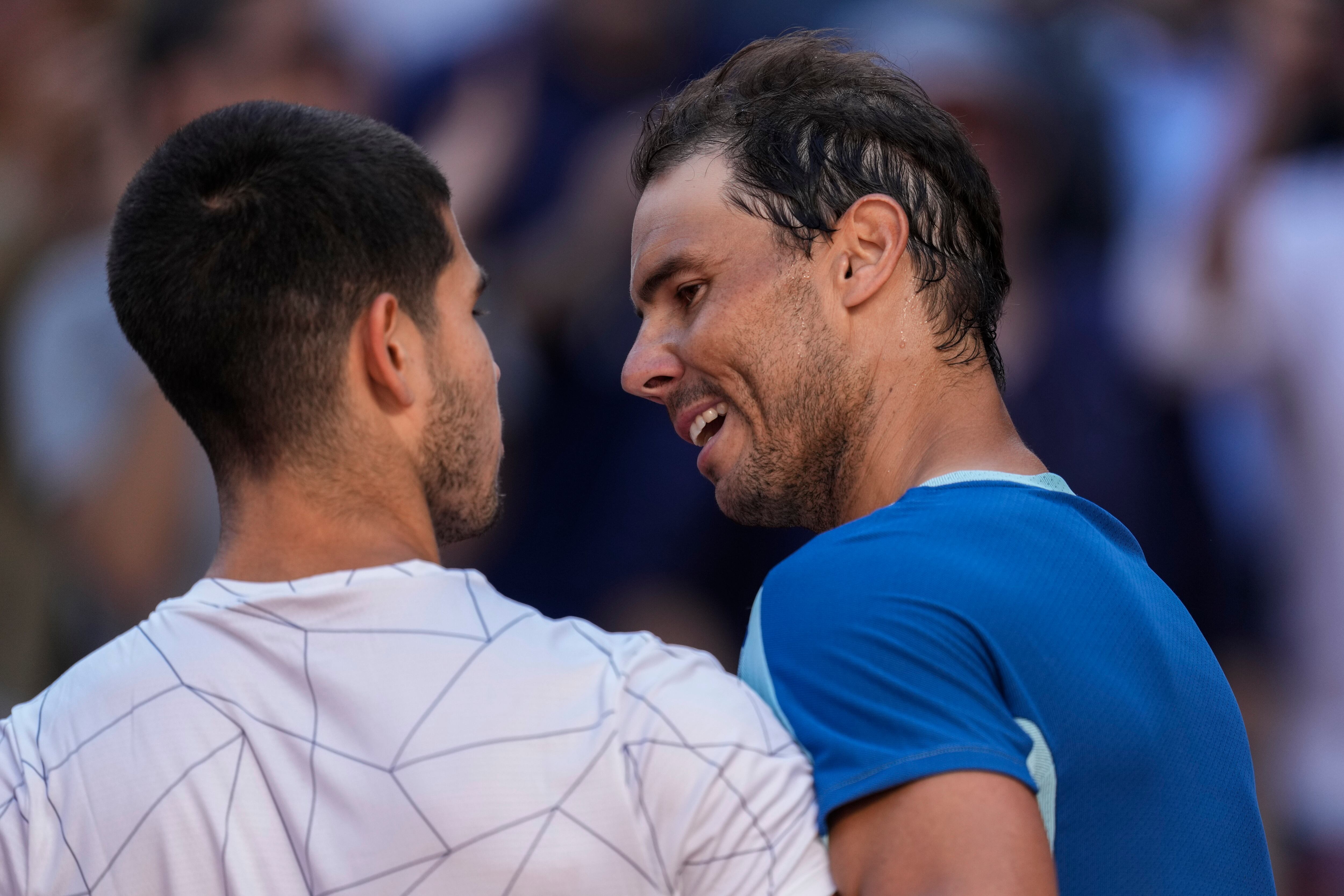 Spain's Rafael Nadal, right, congratulates Spain's Carlos Alcaraz after their match at the Mutua Madrid Open tennis tournament in Madrid, Friday, May 6, 2022. (AP Photo/Bernat Armangue)