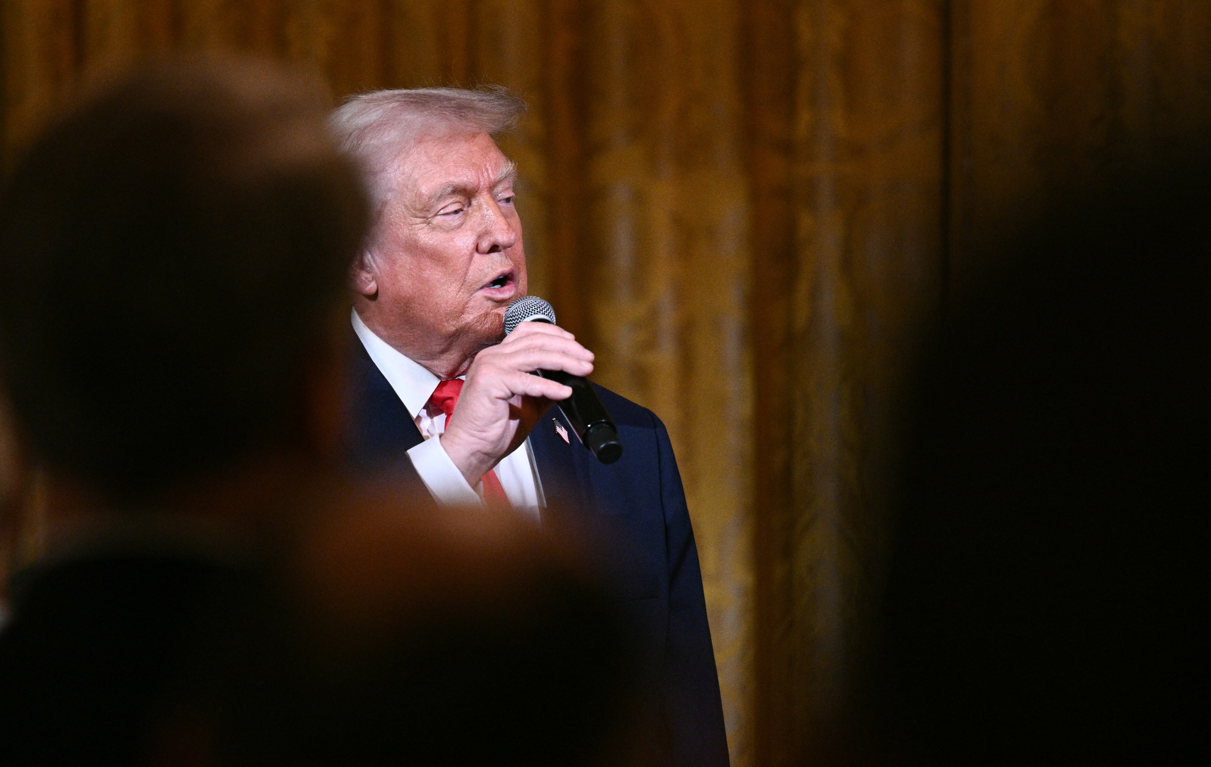 US President Donald Trump delivers remarks before attending a concert by Italian tenor Andrea Bocelli in the East Room of the White House in Washington, DC on December 5, 2025. (Photo by Brendan SMIALOWSKI / AFP)