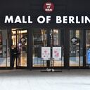 (FILES) In this file photo taken on April 01, 2021 a man walks past the entry to a shopping mall in Berlin, amid the novel coronavirus / COVID-19 pandemic and just before the Easter holidays. - People who have been fully vaccinated against Covid-19 will no longer have to abide by curfews and contact restrictions in Germany under a draft law agreed by the cabinet on Mai 4, 2021. (Photo by Tobias Schwarz / AFP)