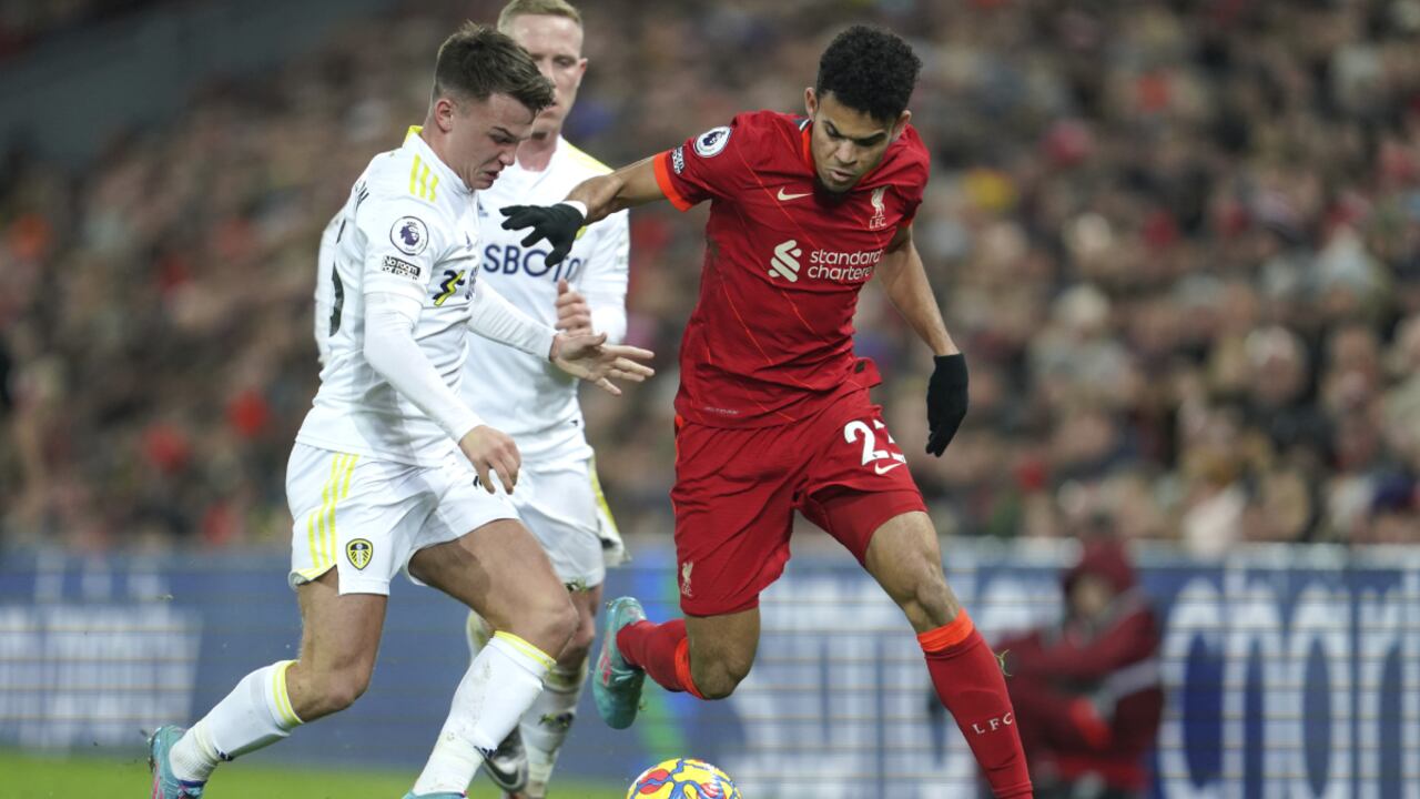 Liverpool's Luis Diaz, right, fights for the ball with Leeds United's Jamie Shackleton during the English Premier League soccer match between Liverpool and Leeds United at Anfield stadium in Liverpool, England, Wednesday, Feb. 23, 2022. (AP Photo/Jon Super)