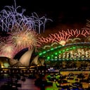 Fireworks explode over the Sydney Harbour Bridge and Sydney Opera House (L) during New Year's Eve celebrations in Sydney on January 1, 2024. (Photo by Izhar KHAN / AFP)