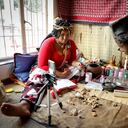 Traditional healer Gogo Kamo (L), does an online consultation with a client in her consultation room in Kempton Park, South Africa on April 16, 2021. - Known as "sangomas" in Zulu language, traditional healers are qualified herbalists, councillors and community mediators as well as diviners.
Many South Africans consult healers for various illness, dream interpretations and conflict resolution.
Shrouded in misconception, sangomas were banned in 1957 under the "Witchcraft Suppression Act" and only legally recognised decades later as "traditional health practitioners".
The passing of knowledge skipped a generation as a result, with grand-parents training millenial grand-children more inclined to break with tradition.
Many traditional healers had to digitalise an ancient practice to continue offering consultations amid strict coronavirus restrictions last year.
The shift has spurred a budding pre-pandemic trend of younger traditional healers already engaging clients through social media and video calls. (Photo by Guillem Sartorio / AFP)