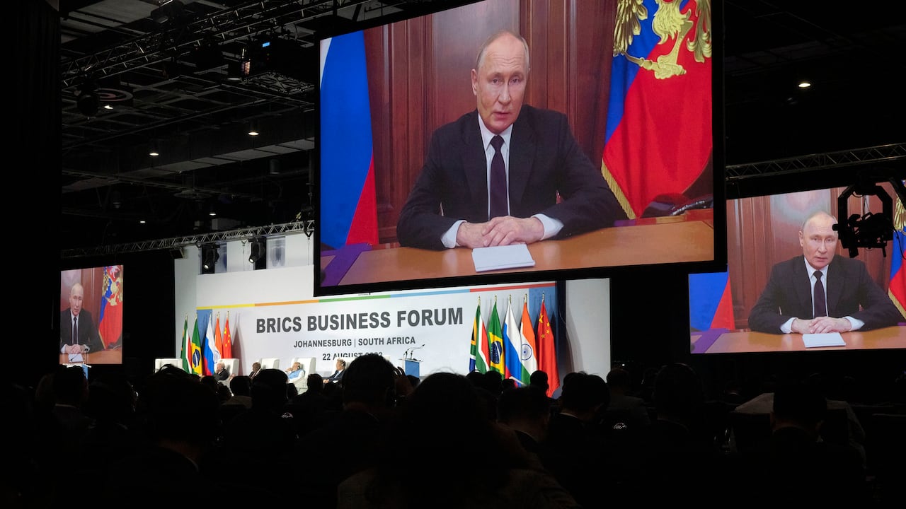 Russian President Vladimir Putin addresses leaders from the BRICS group of emerging economies at the start of a three-day summit in Johannesburg, South Africa , Tuesday, Aug. 22, 2023. Putin appeared on a video link after his travel to South Africa was complicated by an International Criminal Court arrest warrant against him over the war in Ukraine. (AP Photo/Jerome Delay)