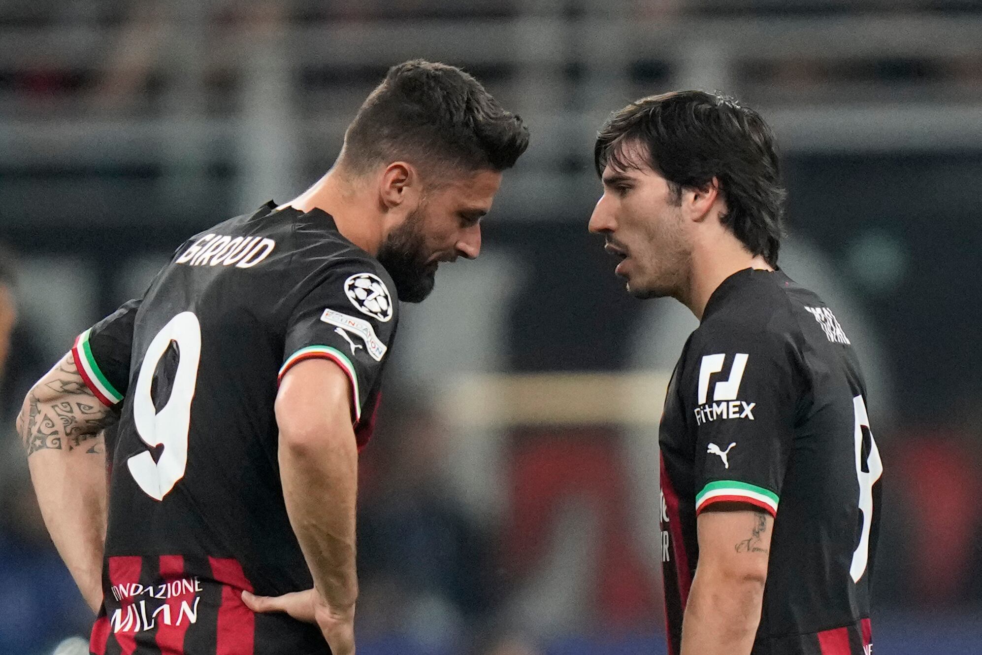 AC Milan's Olivier Giroud, left, talks to AC Milan's Sandro Tonali during the Champions League semifinal first leg soccer match between AC Milan and Inter Milan at the San Siro stadium in Milan, Italy, Wednesday, May 10, 2023. (AP Photo/Luca Bruno)