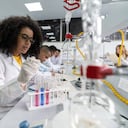 African American woman in a science class making experiments at the lab using test tubes and pipets