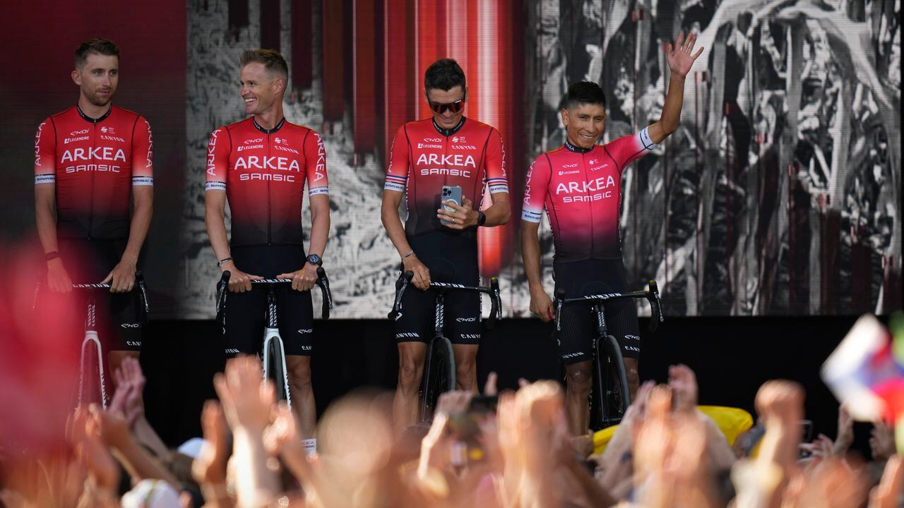 Colombia's Nairo Quintana, right, and other Arkea Samsic team riders greet cheering fans during the team presentation ahead of the Tour de France cycling race in Copenhagen, Denmark, Wednesday, June 29, 2022. The race starts Friday, July 1, the first stage is an individual time trial over 13.2 kilometers (8.2 miles) with start and finish in Copenhagen. (AP Photo/Daniel Cole)