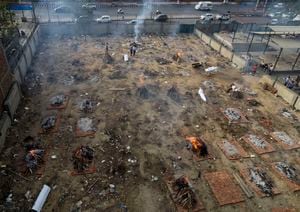 Multiple funeral pyres of victims of COVID-19 burn in a ground that has been converted into a crematorium for mass cremation, in New Delhi, India, Wednesday, April 21, 2021. India’s underfunded health system is tattering as the world’s worst coronavirus surge wears out the nation, which set a global record in daily infections for a second straight day with 332,730. (AP Photo)