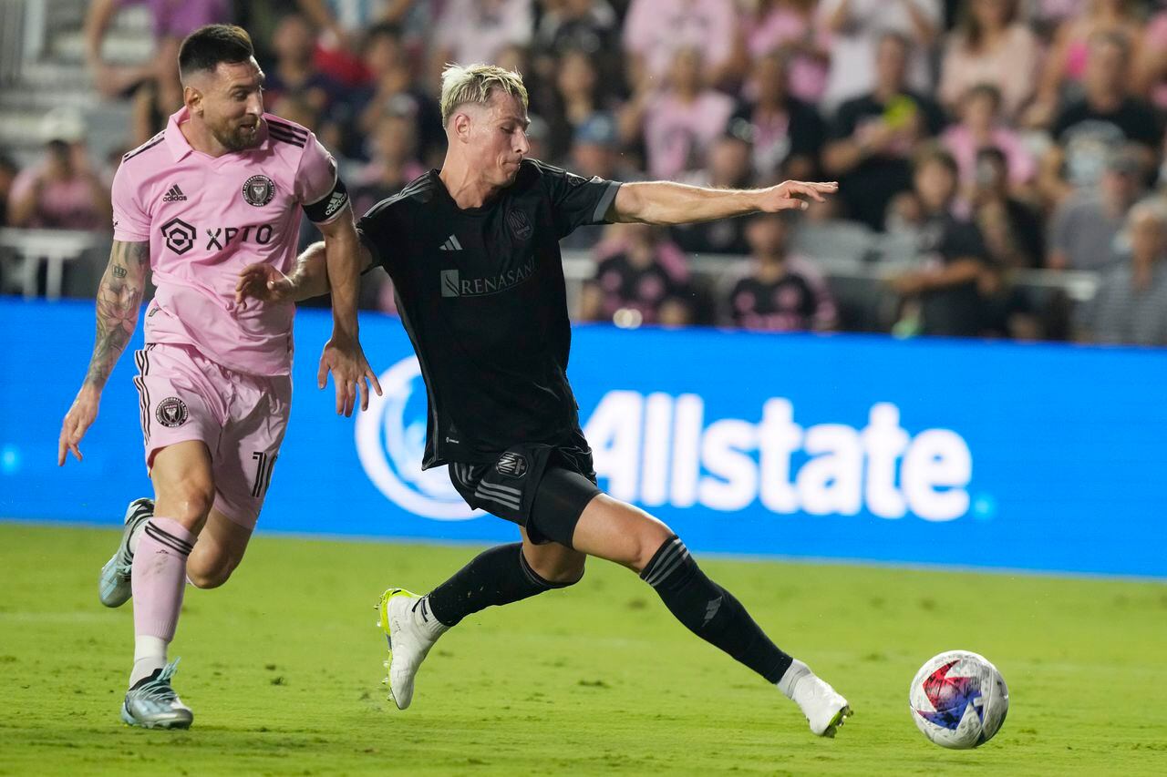 Nashville SC defender Lukas MacNaughton (3) defends Inter Miami forward Lionel Messi (10) during the first half of an MLS soccer match, Wednesday, Aug. 30, 2023, in Fort Lauderdale, Fla. (AP Photo/Marta Lavandier)