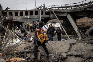 Los residentes de Irpin huyen de los intensos combates a través de un puente destruido cuando las fuerzas rusas ingresaron a la ciudad el 7 de marzo de 2022. (Foto: Chris McGrath/Getty Images)