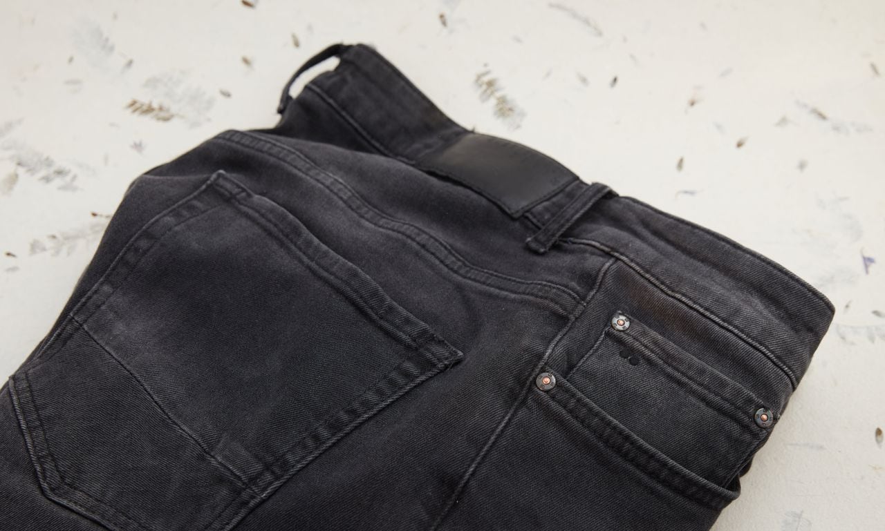 Black slim jeans close-up. Decorative surface. High point of view.
