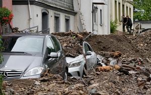 Cars are covered in Hagen, Germany, Thursday, July 15, 2021 with the debris brought by the flooding of the 'Nahma' river the night before. People have died and dozens of people are missing in Germany after heavy flooding turned streams and streets into raging torrents, sweeping away cars and causing some buildings to collapse.  (AP Photo/Martin Meissner)