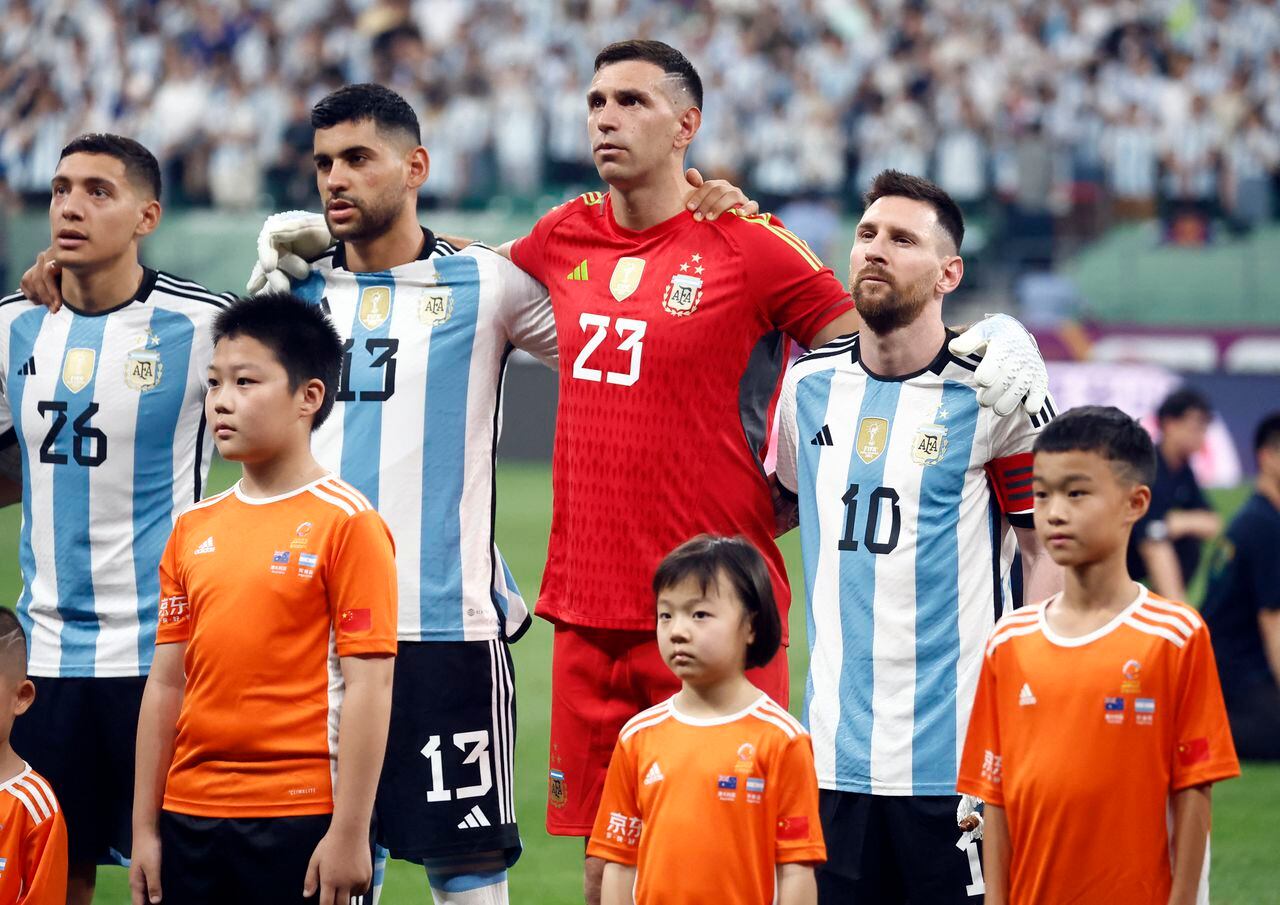 Soccer Football - Friendly - Argentina v Australia - Workers' Stadium, Beijing, China - June 15, 2023 Argentina's Lionel Messi, Emiliano Martinez, Cristian Romero and Nahuel Molina line up during the national anthems before the match REUTERS/Thomas Peter