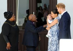 FILE - In this Sept. 25, 2019, file photo, Britain's Prince Harry and Meghan, Duchess of Sussex, holding their son Archie, meet Anglican Archbishop Emeritus, Desmond Tutu and his wife Leah in Cape Town, South Africa. Almost as soon as Meghan and Prince Harry's interview with Oprah Winfrey aired, many were quick to deny Meghan’s allegations of racism on social media. Many say it was painful to watch Meghan’s experiences with racism invalidated by the royal family, members of the media and the public, offering up yet another example of a Black woman’s experience being disregarded and denied. (Henk Kruger/Pool via AP, File)