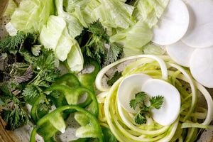 Fresh green raw vegetables and herbs spaghetti zucchini. white radish. green paprika. ice salad for cooking vegan dinner salad. Top view. close up. (Photo by: Natasha Breen/REDA&CO/Universal Images Group via Getty Images)
