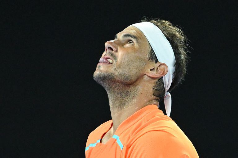 Spain's Rafael Nadal reacts as he plays against USA's Mackenzie McDonald during their men's singles match on day three of the Australian Open tennis tournament in Melbourne on January 18, 2023. (Photo by MANAN VATSYAYANA / AFP) / -- IMAGE RESTRICTED TO EDITORIAL USE - STRICTLY NO COMMERCIAL USE --