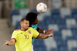 Colombia's Edwin Cardona, left, and Ecuador's Angelo Preciado head for the ball during a Copa America soccer match at Arena Pantanal stadium in Cuiaba, Brazil, Sunday, June 13, 2021. (AP Photo/Andre Penner)