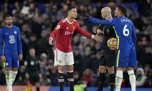 Manchester United's Cristiano Ronaldo talks to Referee Anthony Taylor while Chelsea's Thiago Silva, right, gestures during the English Premier League soccer match between Chelsea and Manchester United at Stamford Bridge stadium in London, Sunday, Nov. 28, 2021. (AP Photo/Kirsty Wigglesworth)