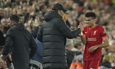 Liverpool's Luis Diaz, right, is congratulated by his manager Jurgen Klopp during the English Premier League soccer match between Liverpool and Manchester United at Anfield stadium in Liverpool, England, Tuesday, April 19, 2022. (AP/Jon Super)