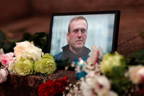 Se colocan flores y una vela junto a un retrato del líder de la oposición rusa Alexei Navalny tras la muerte de Navalny mientras la gente se reúne cerca de la embajada rusa, en París, Francia