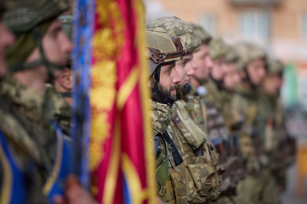 In this photo provided by the Ukrainian Presidential Press Office and posted on Facebook, Ukrainian soldiers line up on a central square during President Volodymyr Zelenskyy's visit to Kherson, Ukraine, Monday, Nov. 14, 2022. Ukraine's retaking of Kherson was a significant setback for the Kremlin and it came some six weeks after Russian President Vladimir Putin annexed the Kherson region and three other provinces in southern and eastern Ukraine — in breach of international law — and declared them Russian territory. (Ukrainian Presidential Press Office via AP)