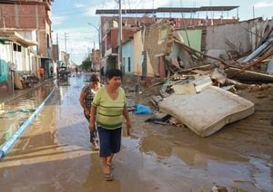 Residents walk among devastated neigborhoods and homes of the semi rural district of Illimo in the Piura region in northern Peru, on March 11, 2023, after heavy rains caused by the presence of an "unorganized cyclone� named Yaku, off the Peruvian coast, in the waters of the Pacific Ocean, according to the authorities. - The floods, accompanied by strong winds that affect part of Peru, started this week and grew in proportions in the last 48 hours, affecting urban and rural areas of the coastal departments of La Libertad, Lambayeque, Piura and Tumbes, on the border with Ecuador. "Cyclone Yaku is a very unusual phenomenon causing intensifying rains in the north," said the director of Civil Defense, C�sar Sierra. The the cyclone is located some 500 kilometers west from the Peruvian coast, according to the Peruvian Meteorological Service (Senahmi). (Photo by Jao Yamunaque / AFP)