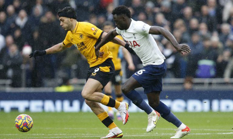 Wolverhampton Wanderers' Raul Jimenez, left vies for the ball with Tottenham's Davinson Sanchez during the English Premier League soccer match between Tottenham Hotspur and Wolverhampton Wanderers and at White Hart Lane in London, Sunday, Feb. 13, 2022. (AP/David Cliff)