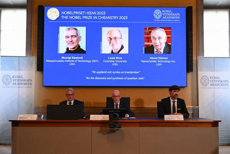 A screen shows this year's laureates US Chemist Moungi Bawendi, US Chemist Louis Brus and Russian physicist Alexei Ekimov during the announcement of the winners of the 2023 Nobel Prize in chemistry at Royal Swedish Academy of Sciences in Stockholm on October 4, 2023. French-born Moungi Bawendi, Louis Brus of the United States and Russian-born Alexei Ekimov  won the Nobel Chemistry Prize for research in semiconductor nanocrystals known as quantum dots. (Photo by Jonathan NACKSTRAND / AFP)