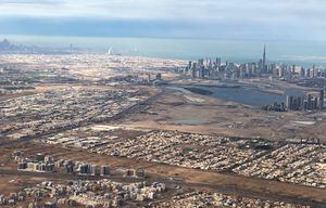 Una vista aérea tomada el 1 de enero de 2022 desde un avión de pasajeros muestra una vista general del Emirato del Golfo de Dubai con la capital de los Emiratos Árabes Unidos, Abu Dhabi, al fondo.
