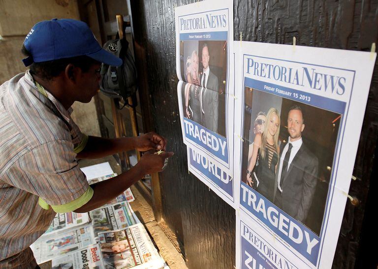 A newspaper vendor sets up his stall outside court ahead of South African "Blade Runner" Oscar Pistorius' court appearance in Pretoria  February 15, 2013. REUTERS/Siphiwe Sibeko/File Photo