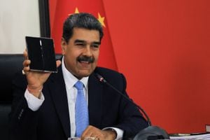 In this handout picture released by the Miraflores press office, Venezuela's President Nicolas Maduro shows a mobile gifted by Chinese President Xi Jinping while speaking during a conference with the international press in Beijing on September 14, 2023. Venezuelan President Nicolas Maduro has said his country could soon send its first astronauts to the Moon in a Chinese spacecraft, hailing on September 14 a scientific cooperation agreement reached with President Xi Jinping. (Photo by JHONN ZERPA / Venezuelan Presidency / AFP) / RESTRICTED TO EDITORIAL USE - MANDATORY CREDIT "AFP PHOTO / VENEZUELAN PRESIDENCY / Jhonn ZERPA" - NO MARKETING - NO ADVERTISING CAMPAIGNS - DISTRIBUTED AS A SERVICE TO CLIENTS