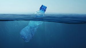 La botella de plástico de basura flota en agua de mar azul bajo el agua. Contaminación del medio ambiente y de los océanos.