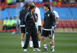 JOHANNESBURG, SOUTH AFRICA - JUNE 12:  Diego Maradona head coach of Argentina conducts warm up exercises with striker Lionel Messi of Argentina ahead of the 2010 FIFA World Cup South Africa Group B match between Argentina and Nigeria at Ellis Park Stadium on June 12, 2010 in Johannesburg, South Africa.  (Photo by Ezra Shaw/Getty Images)