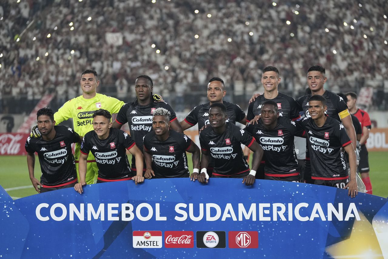 The starting players of Colombia's Independiente Santa Fe pose for a team photo prior to a Copa Sudamericana group G soccer match against Peru's Universitario at Monumental stadium in Lima, Peru, Thursday, May 4, 2023. (AP Photo/Martin Mejia)