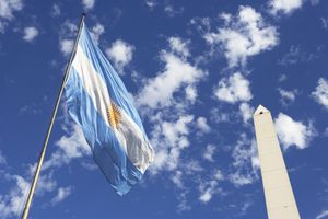 Argentinean flag and Obelisco in Buenos Aires, Argentina, South America.